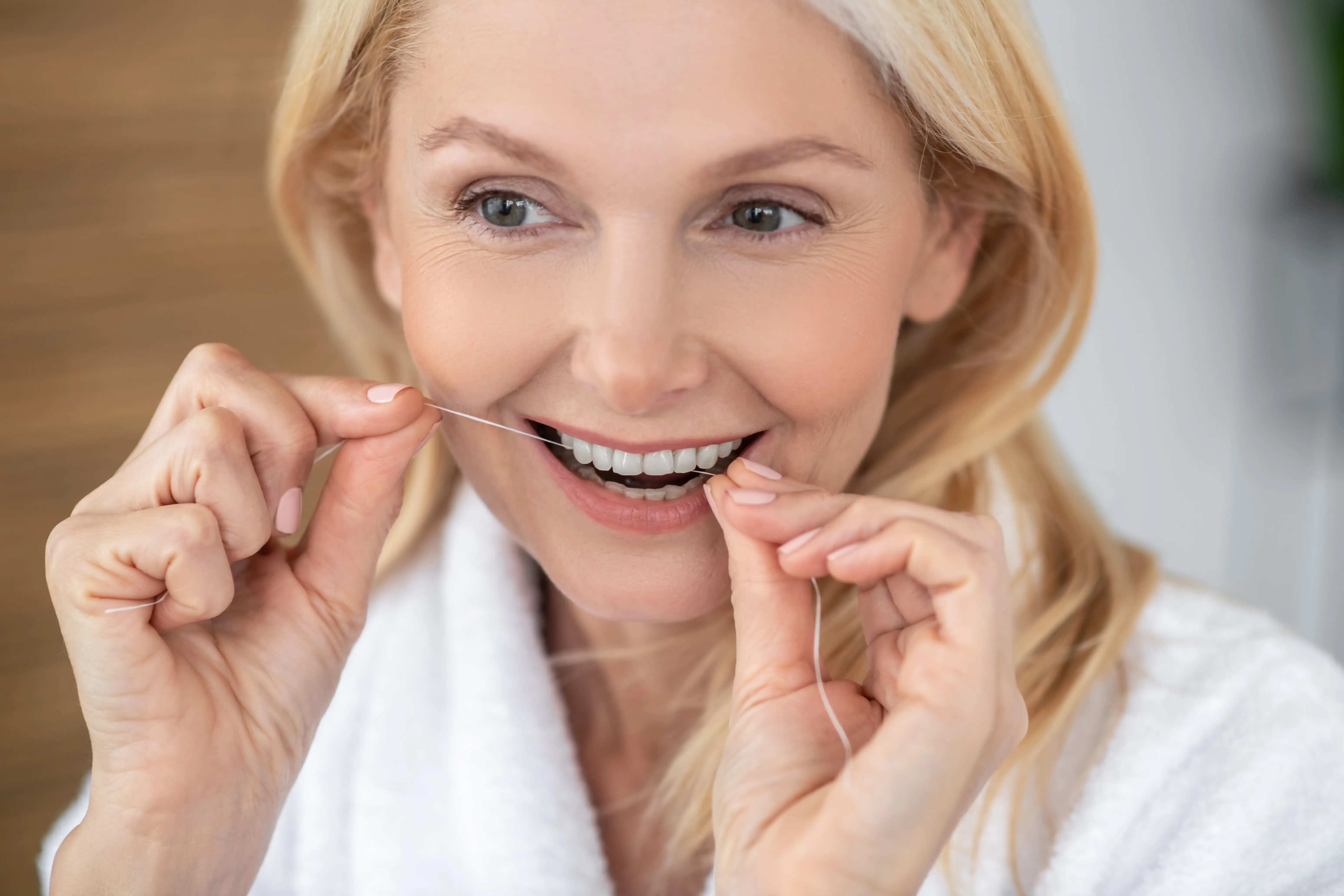 Woman flossing her teeth