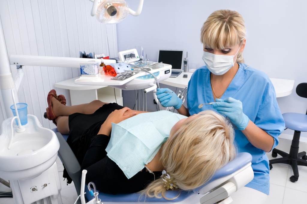 doctor works patient dentist office