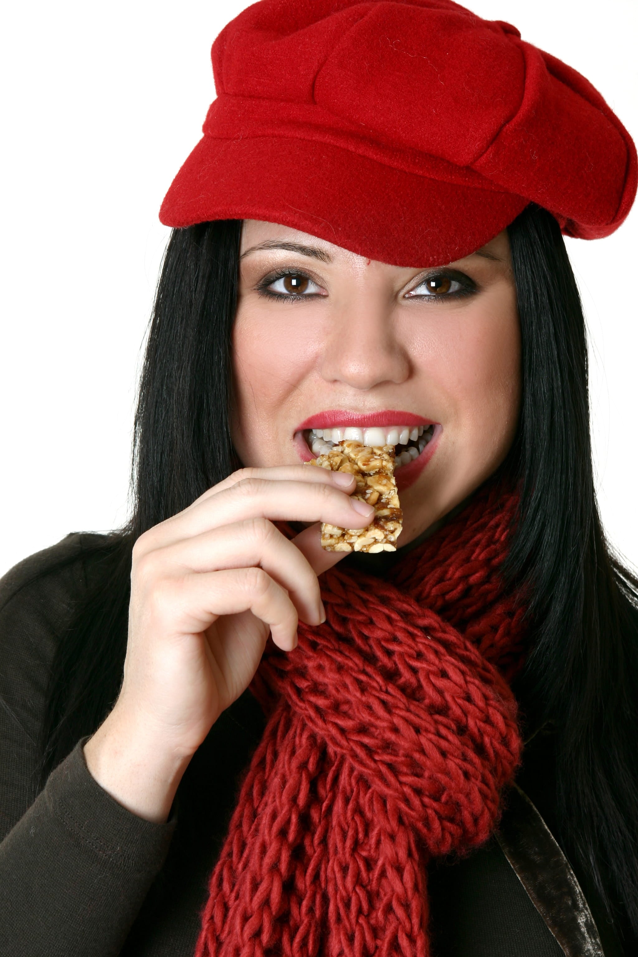 female with healthy strong teeth eating granola bar
