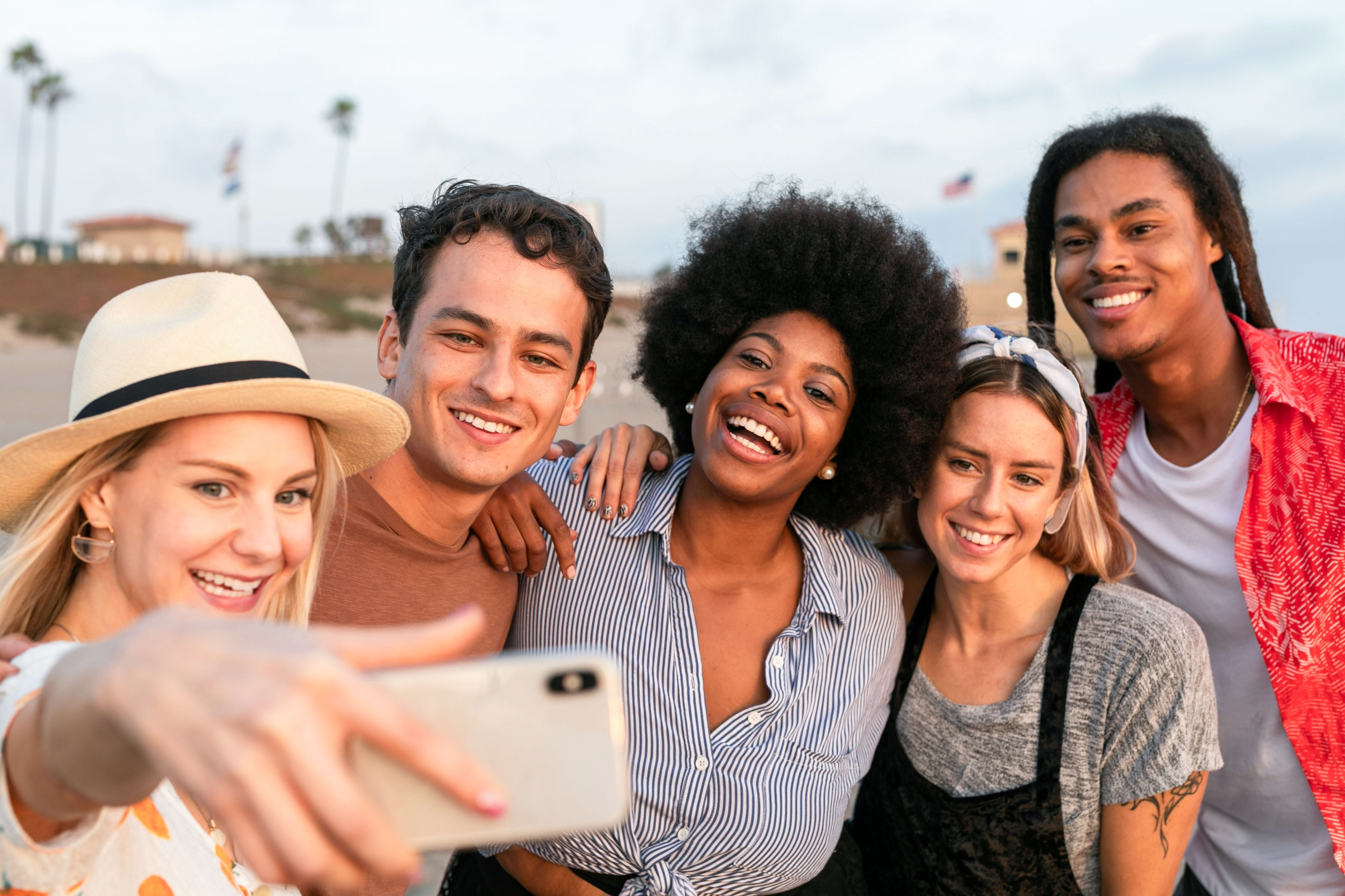 diverse group friends smiling taking selfie
